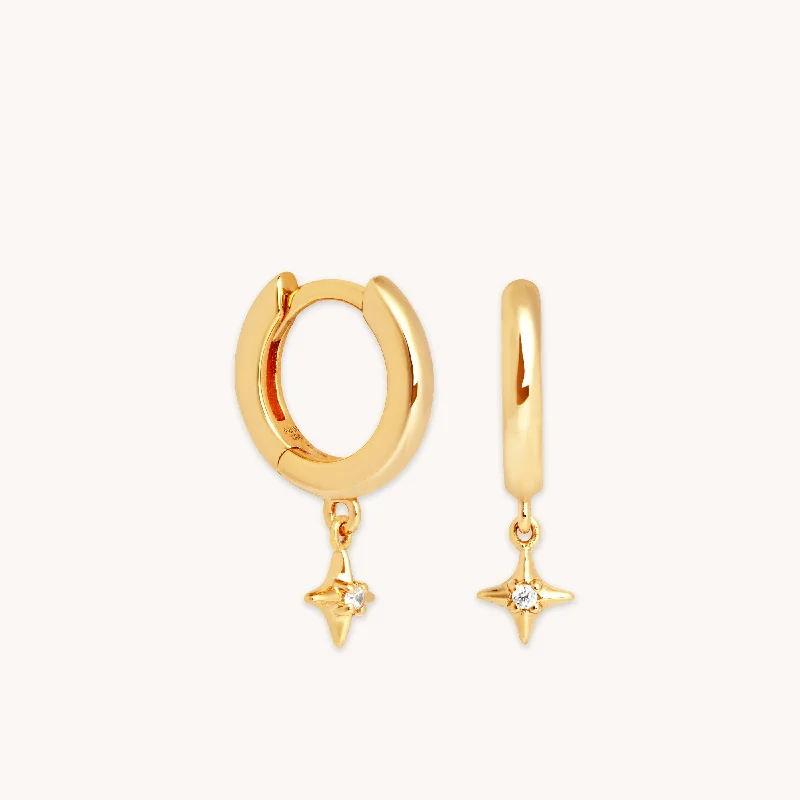 Hoop earrings with intricate designs for a unique and artistic appearance-Cosmic Star Charm Huggies in Gold